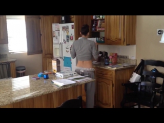 the husband spied what his wife was doing in the kitchen.