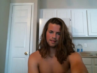 long haired guy playing with dildo